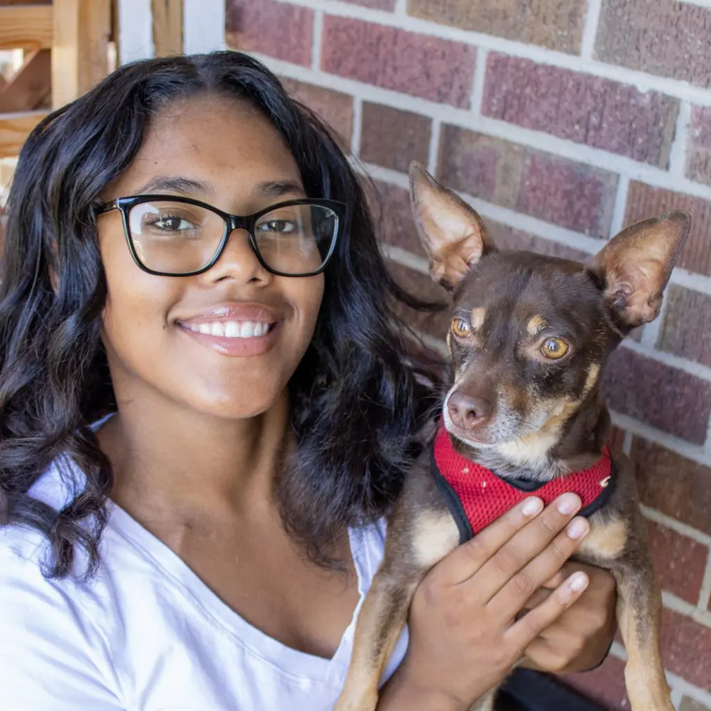 young girl holding her stink bug dog