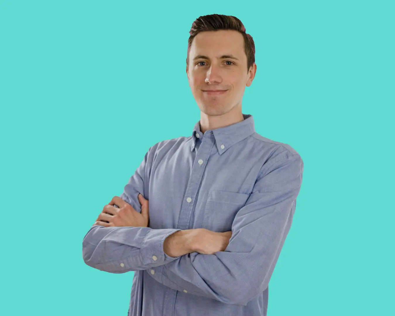 Garrett Deitemeyer with his arms corssed over a blue background