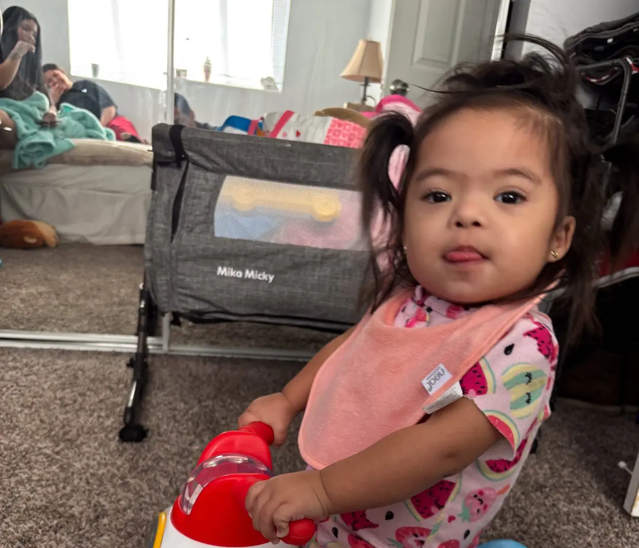Little girl rides a bike in her home