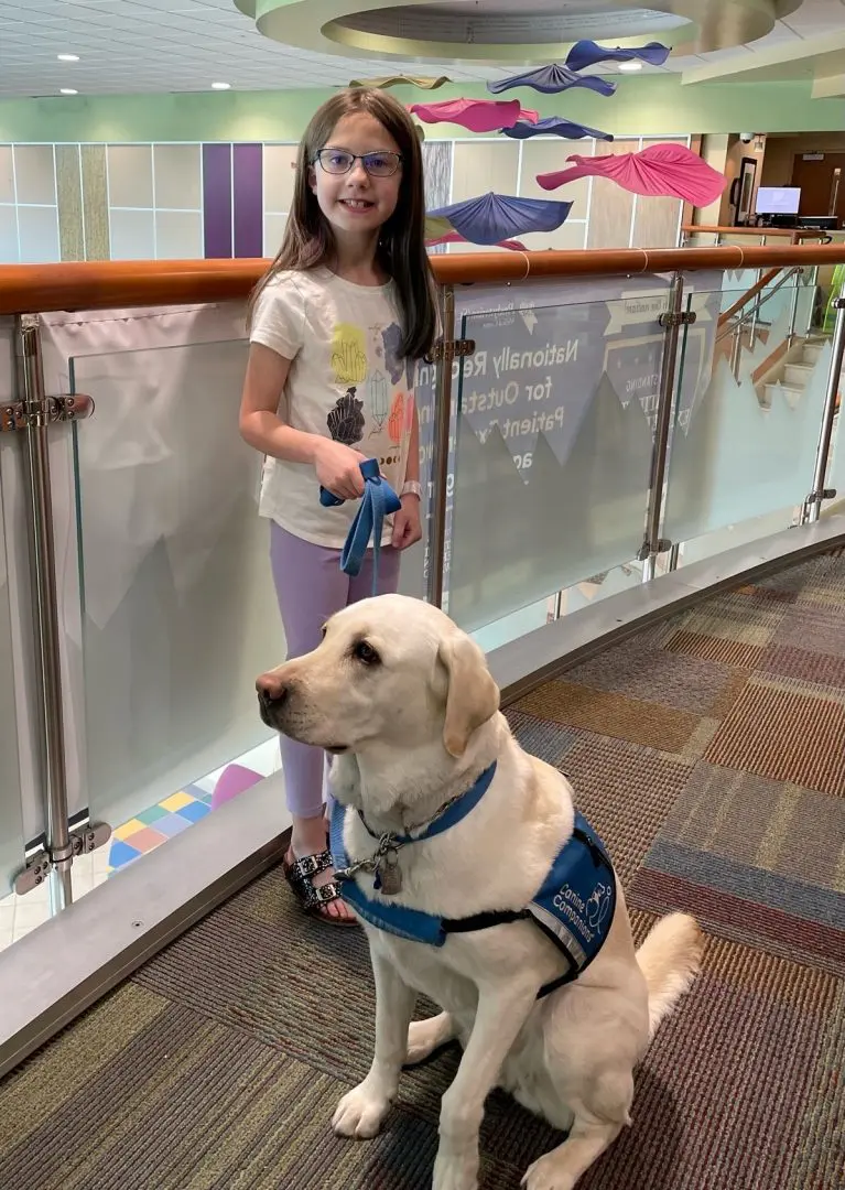 Little girl and facility dog
