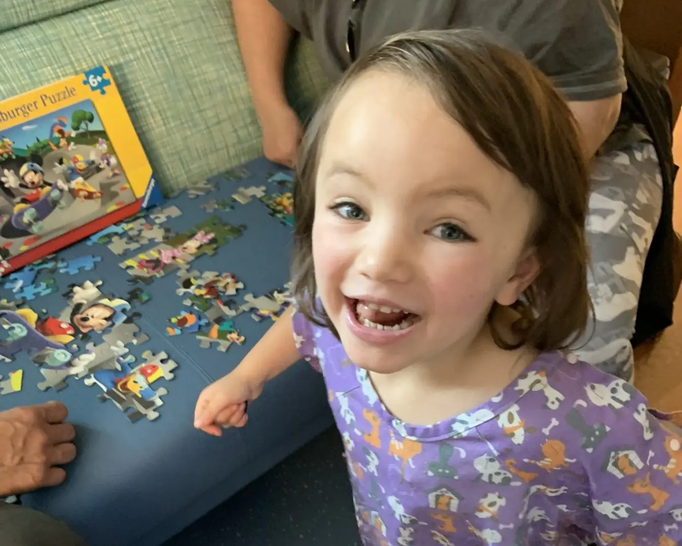 Little girl building a puzzle. Toys like this are made possible by people giving generous donations