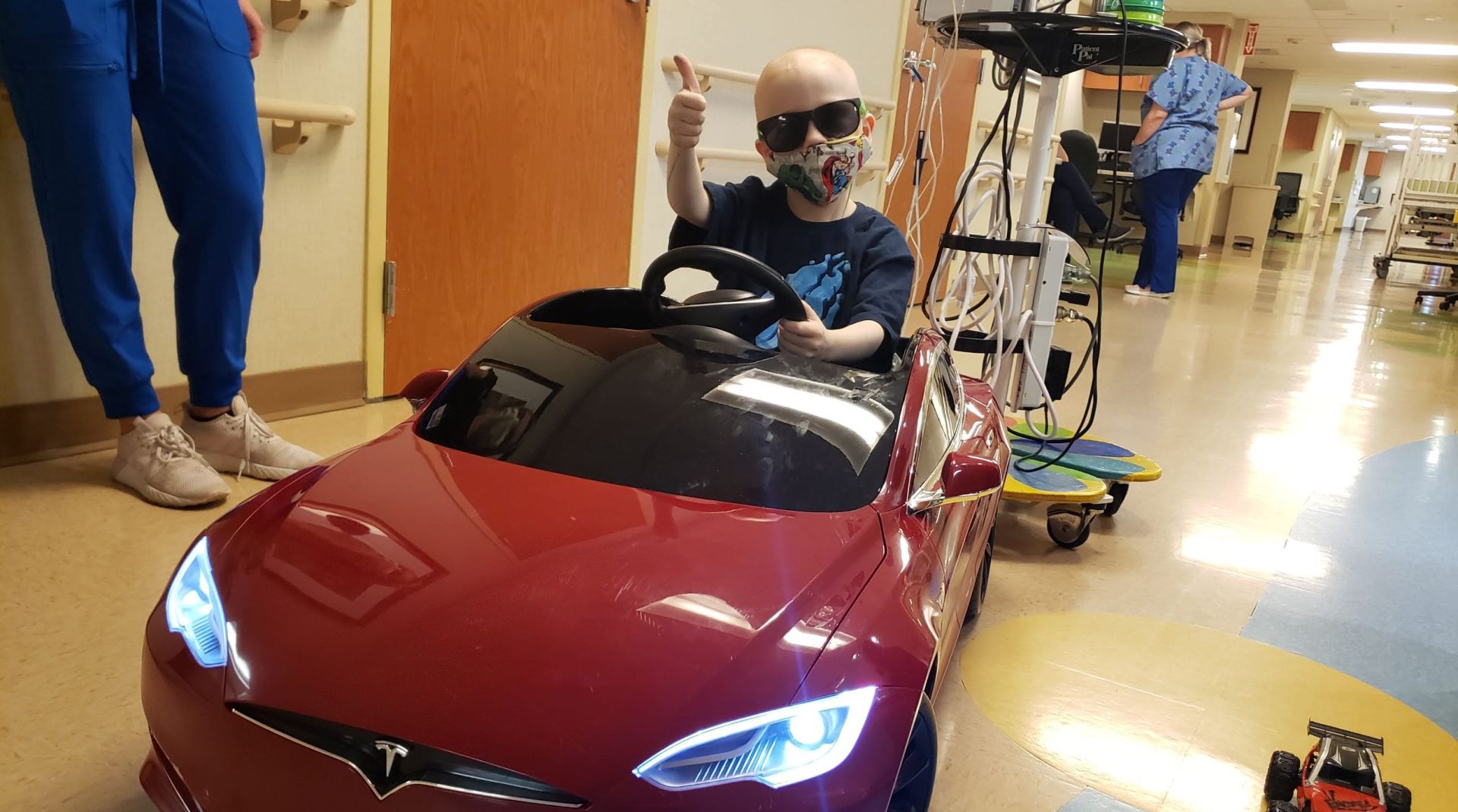 Pediatric patient at Rocky Mountain Children’s Health Foundation hospital enjoying a toy car, supporting children during medical treatment